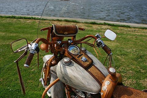 1973 Ford Ranchero - This motorcycle features extensive leatherwork on its tank, seat, and saddlebags, with a clear windshield and mirrors.