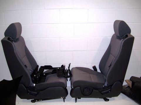 1971 Ford Ranchero - Two car seats are shown, detached from a vehicle, against a white brick wall.