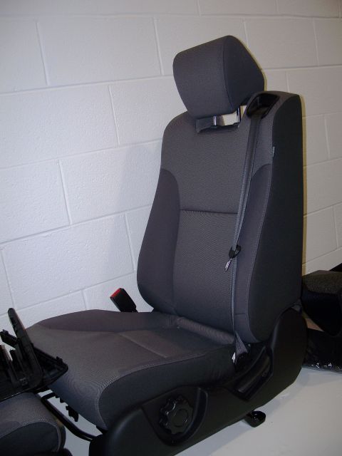 1971 Ford Ranchero - This is a gray car seat with a headrest and seatbelt, likely from a modern vehicle.