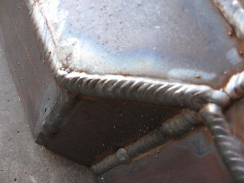1995 Ford F-150 - The photo shows a section of a metal structure with prominent, heavy welds.