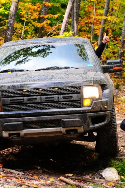 1996 Ford Bronco - A Ford F-150 Raptor gives a thumbs-up while navigating an off-road trail.