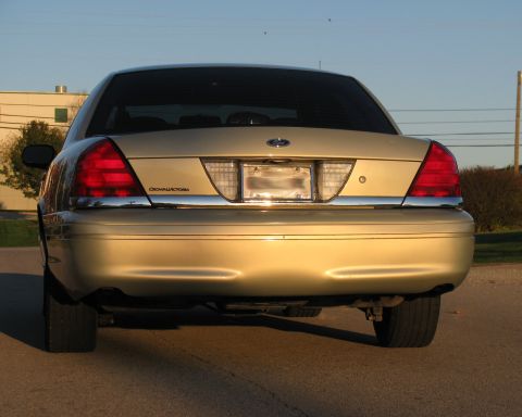 2004 Ford Crown Victoria - Rear view of a gold 2004 Ford Crown Victoria with chrome accents.