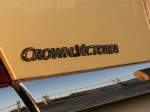 2004 Ford Crown Victoria - The 'Crown Victoria' emblem is visible on the rear of the vehicle.