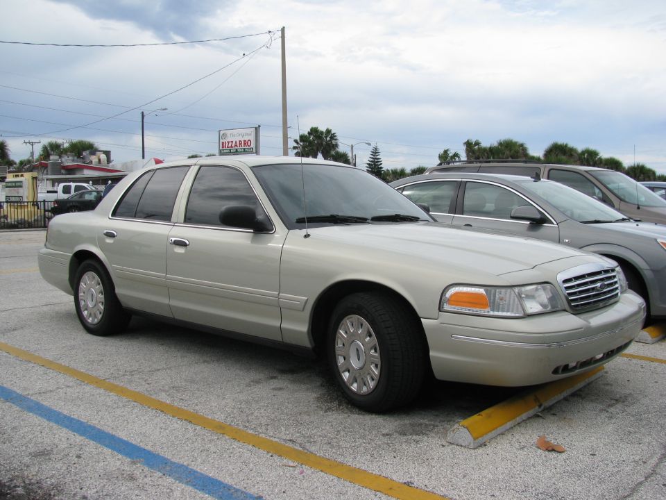 Champagne Ford Crown Victoria sedan in a used car lot