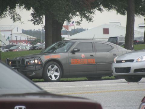 2004 Ford Crown Victoria - A Georgia State Patrol car is parked next to another vehicle.