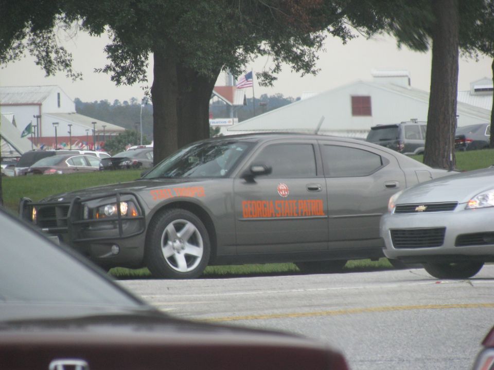 Gray Dodge Charger Georgia State Patrol car with push bumper parked beside a road