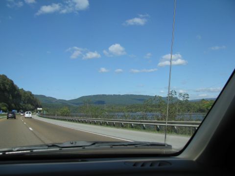 2004 Ford Crown Victoria - Driving on a highway with a scenic view of mountains and a body of water.