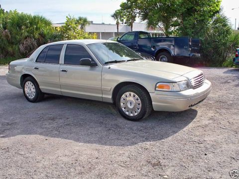 2004 Ford Crown Victoria - Silver 2004 Ford Crown Victoria parked outdoors on a gravel surface.