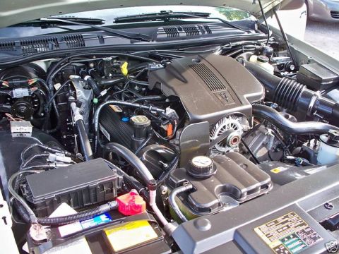 2004 Ford Crown Victoria - The engine bay of a 2004 Ford Crown Victoria is visible, with various components of the V8 engine clearly displayed.