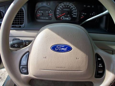 2004 Ford Crown Victoria - Interior view of a 2004 Ford Crown Victoria, the steering wheel, dashboard, and instrument cluster.
