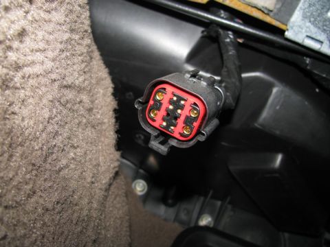 2004 Ford Crown Victoria - An electrical connector with multiple gold pins is visible in the interior of a vehicle.