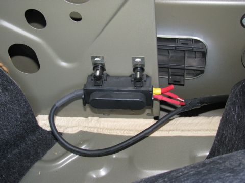 2004 Ford Crown Victoria - In the trunk, behind the carpet on the passenger side fender.