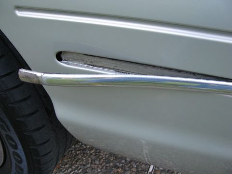 2004 Ford Crown Victoria - The bumper strips tuck into each side of the fascia.