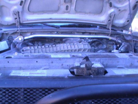 1997 Ford Ranger - The engine bay of a vehicle is shown with the hood up, revealing the engine and various components.