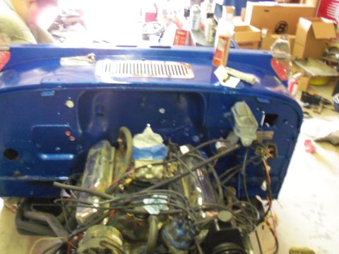 1978 Jeep CJ5 - The engine bay of a blue 1978 Jeep CJ5 shows its engine and various components during a restoration or repair.