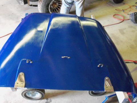 1978 Jeep CJ5 - A blue Jeep hood is shown with visible primer and chrome hardware.