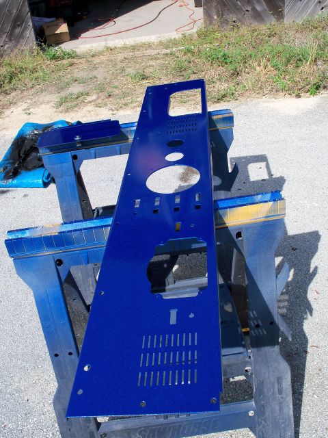 1978 Jeep CJ5 - A freshly painted blue metal panel with multiple openings and ventilation holes is drying on sawhorses.