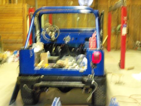 1978 Jeep CJ5 - This 1978 Jeep CJ5 is in a workshop, appearing to be undergoing restoration or repair.