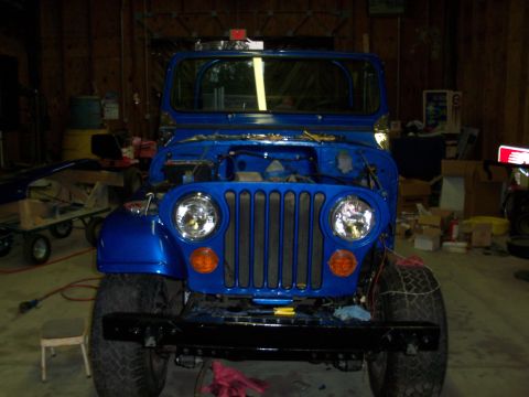 1978 Jeep CJ5 - Front view of a blue 1978 Jeep CJ5 in a garage, hood is open.