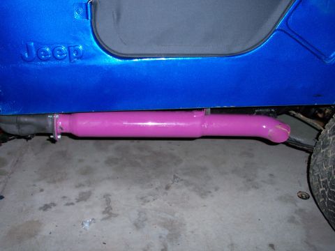 1978 Jeep CJ5 - Side view of a blue Jeep showing the 'Jeep' badging and a custom pink exhaust pipe.