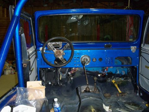 1978 Jeep CJ5 - Interior view of a 1978 Jeep CJ5, a blue dashboard and roll cage.