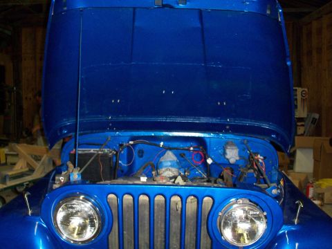 1978 Jeep CJ5 - Front view of a blue 1978 Jeep CJ5 with its hood open, revealing the engine bay and iconic vertical grille.
