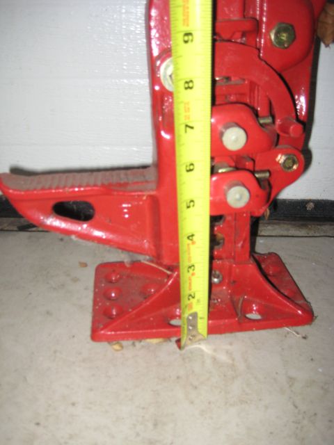 1995 Ford Bronco - A red hi-lift jack is shown with a yellow measuring tape indicating its height.
