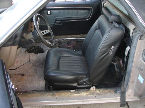 1973 Ford Ranchero - The interior of the vehicle shows exposed wiring and missing carpet, indicating it is undergoing restoration.