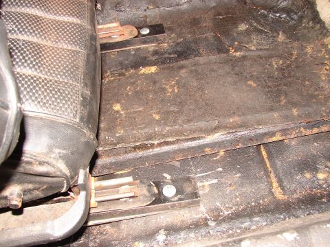 1973 Ford Ranchero - The interior floor and seat mounting hardware show significant rust and wear.