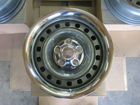 1999 Ford Crown Victoria - A Ford wheel with a chrome trim ring is shown, the Ford logo on the center cap.
