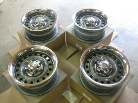 1999 Ford Crown Victoria - Set of four steel wheels with chrome trim rings, ready for installation.