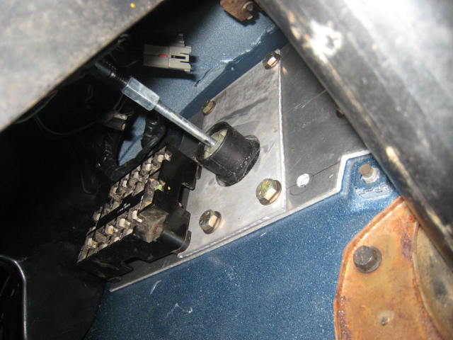 Vehicle shifter or pedal mechanism through a floor opening