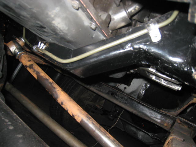 Undercarriage view of frame rails, brake line and drivetrain