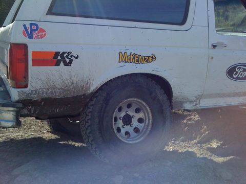 1995 Ford Bronco - Mud splatters and racing decals adorn the rear quarter of this 1995 Ford Bronco.