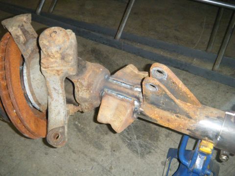 1978 Ford Bronco - Close-up of a modified front axle assembly, showing recent welding work and a brake rotor.
