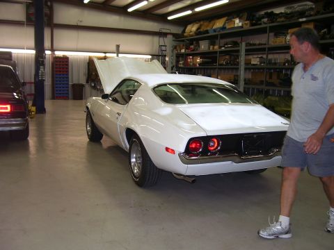 1979 Chevrolet Camaro - A white coupe with its hood open is parked in a garage, with another vehicle visible to the left.