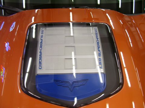 1979 Chevrolet Camaro - Close-up of a car's engine cover, identified as LS9 SUPERCHARGED with a Corvette emblem.