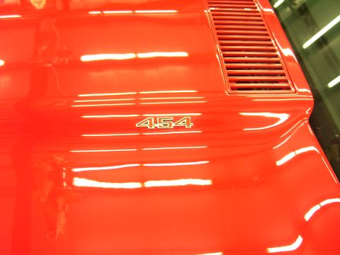 1979 Chevrolet Camaro - Close-up of a red car's hood, a "454" badge and a rear vent detail.