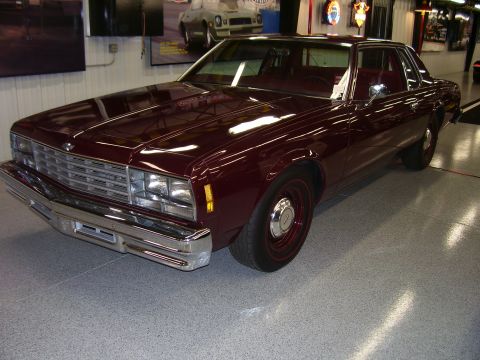 1979 Chevrolet Camaro - This maroon coupe features a prominent chrome grille and bumper, with a distinctive body style.