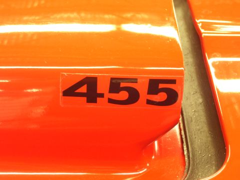 1979 Chevrolet Camaro - Close-up of an orange vehicle's body panel a black '455' decal.