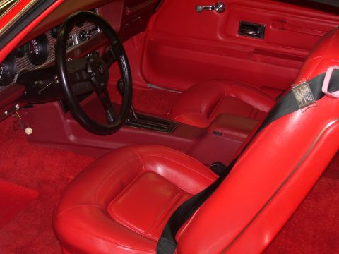 1979 Chevrolet Camaro - The interior of a 1977 Pontiac Firebird Trans Am features red leather seats and matching carpeting.