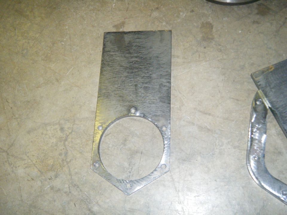 Metal bracket with circular cutout and bolt holes