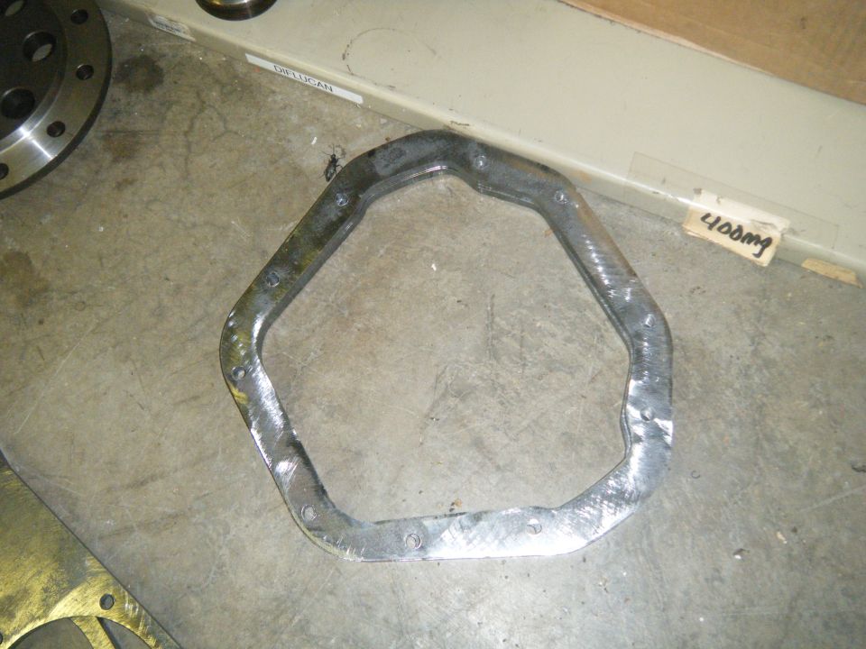 Metal gasket with bolt holes, possibly for an engine or transmission
