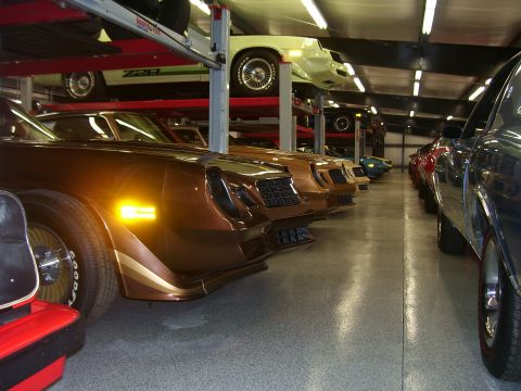 1979 Chevrolet Camaro - A collection of cars are stored in a multi-level garage, with several models visible.