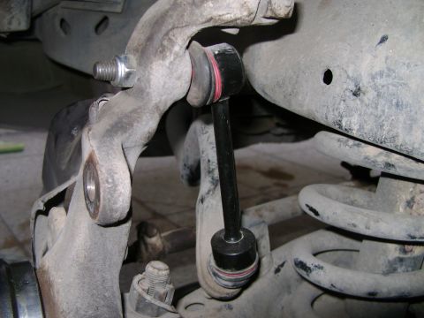 1998 Ford Crown Victoria - A close-up view of a vehicle's suspension linkage, showing a new sway bar link installed.
