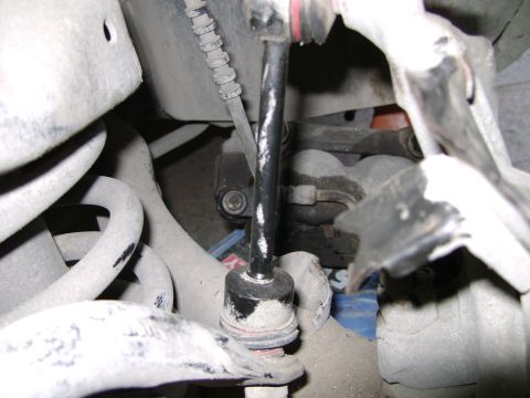 1998 Ford Crown Victoria - Close-up view of a vehicle's front suspension system, focusing on a sway bar link.
