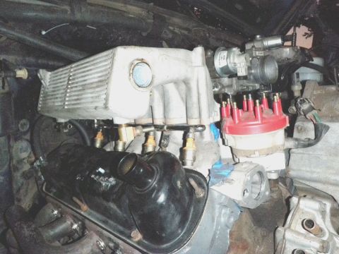 1994 Ford Bronco - Close-up of a Ford V8 engine's intake manifold, fuel injectors, and distributor cap.