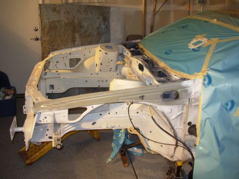 1991 Ford Taurus - Vehicle frame being prepped for paint or bodywork in a garage setting.
