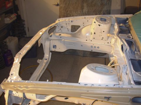 1991 Ford Taurus - The bare frame of a car is shown from the front, with no visible year-identifying features.