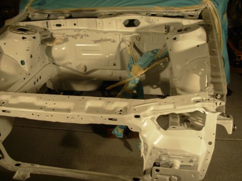 1991 Ford Taurus - The engine bay of a car is shown after being stripped and painted white, with some components covered for protection.